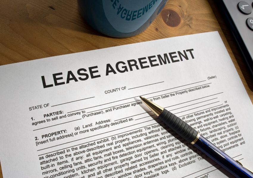 a lease agreement document with a pen on top