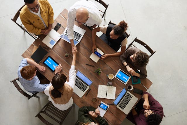 a group of people sitting around a conference table for a meeting