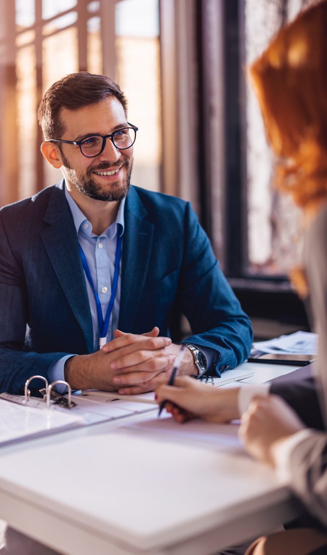 The,Real,Estate,Agent,Closes,The,Deal,With,The,Client Property manager sitting down with a client to sign papers
