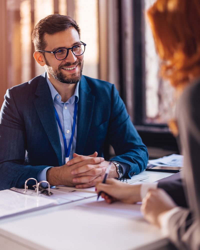 Property manager sitting down with a client to sign papers
