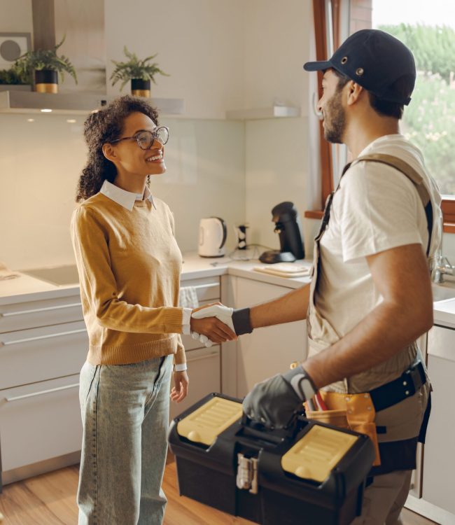 Professional,Repairman,In,Uniform,Shaking,Hands,With,Woman,While,Standing guy at home for repairs