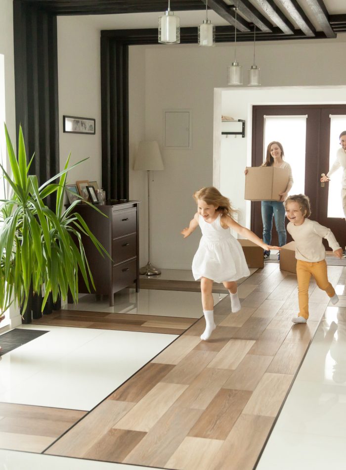 Happy rental tenants moving in with kids playing